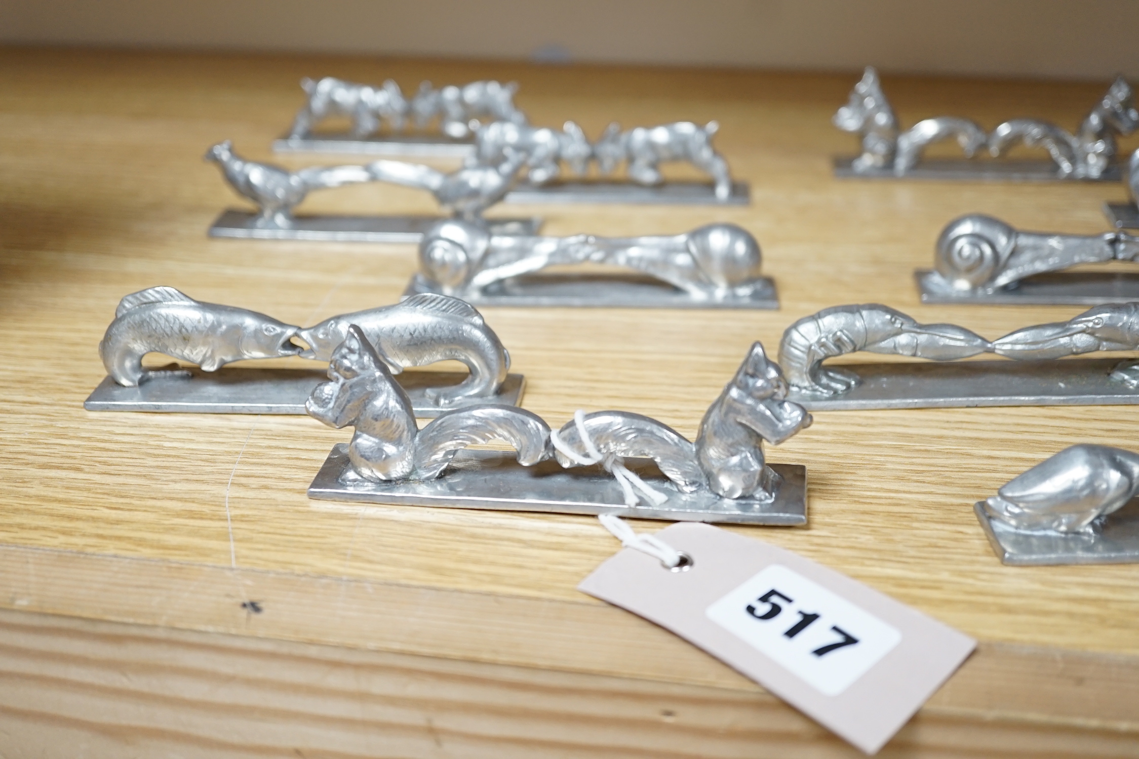 A set of 12 French pewter novelty knife rests, in the form of squirrels, fish, snails, goats, etc.